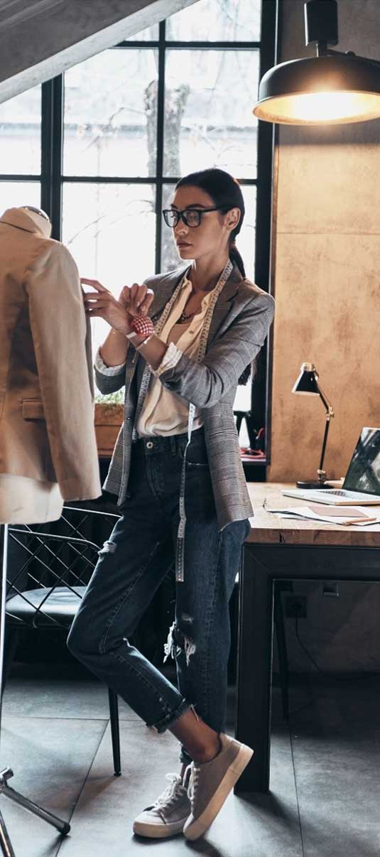 A clothing designer works on a jacket